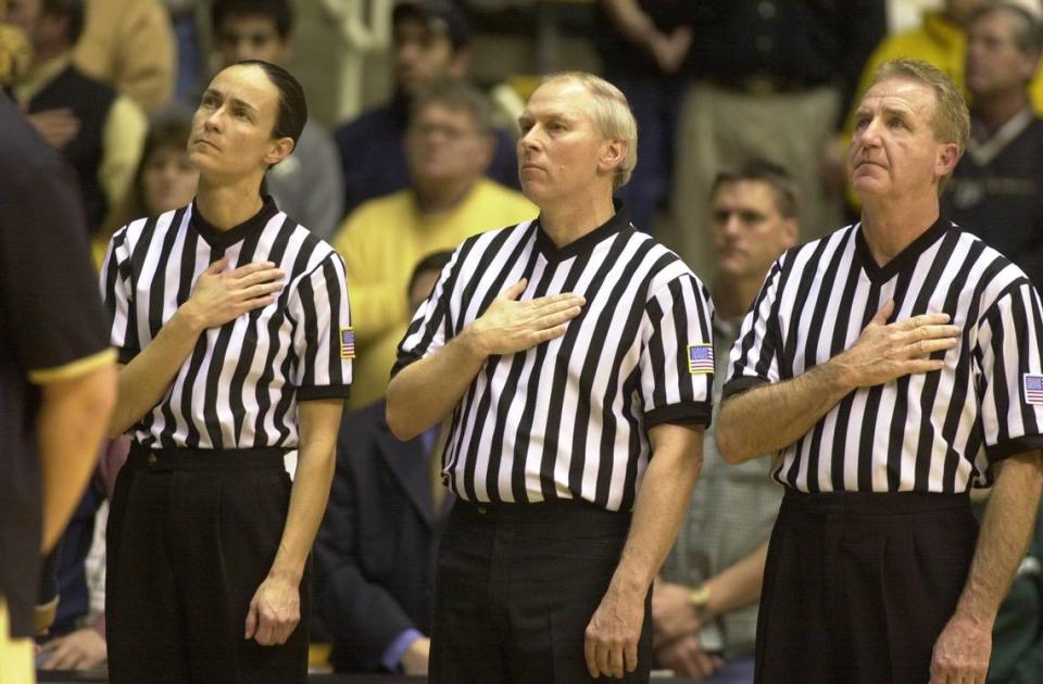 Lisa Mattingly, left, stood at attention during the national anthem before she officiated a game between Purdue and Michigan State at West Lafayette, Ind., in 2003. Before her officiating career, Mattingly played high school basketball at Marion County and college ball at Sue Bennett College and Georgetown College. Janet Worne/Lexington Herald-Leader