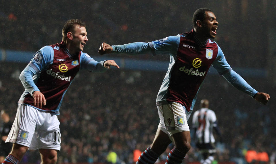 Aston Villa's Leandro Bacuna, right, celebrates scoring the second goal, during the English Premier League match against West Bromwich Albion, at Villa Park, Birmingham, England, Wednesday Jan. 29, 2014. (AP Photo/PA, Nick Potts) UNITED KINGDOM OUT
