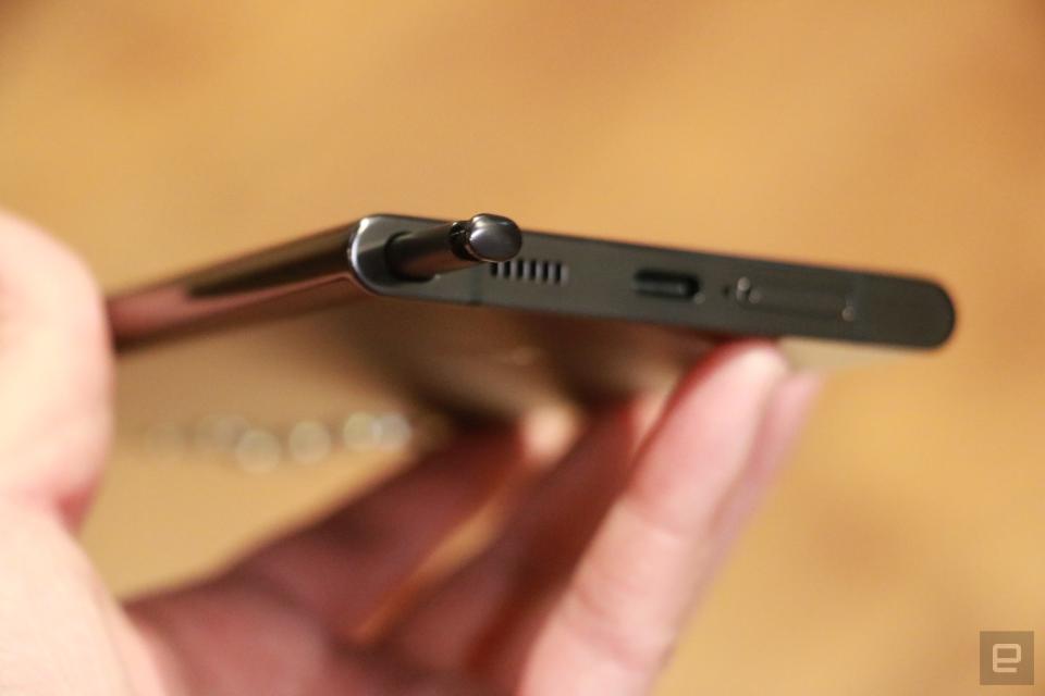 <p>A closeup of the Samsung Galaxy S22 Ultra's S Pen poking out of its onboard slot on the bottom left of the handset.</p>
