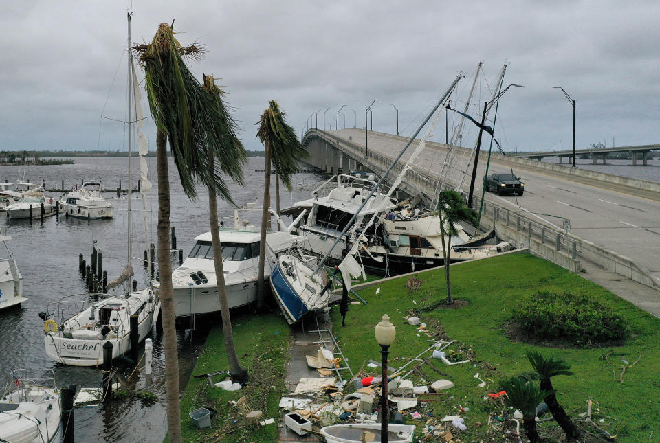 <p>In the aftermath on Sept. 29, several boats sit atop each other in Fort Myers, Florida. </p>