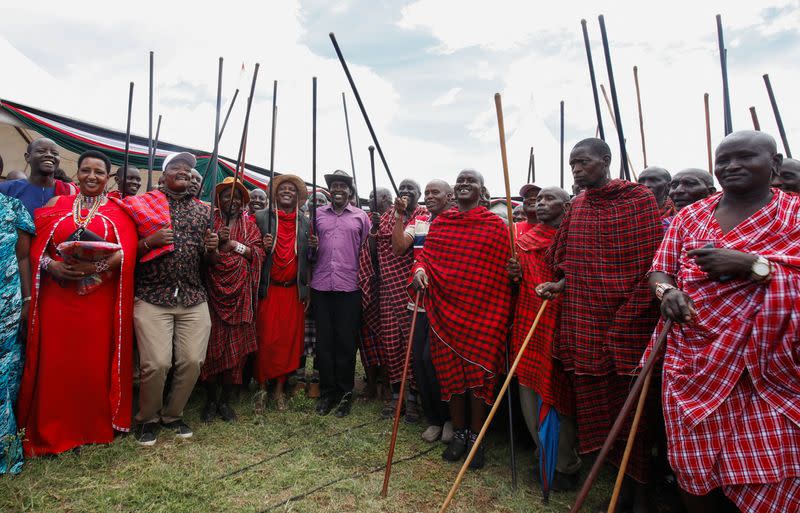 Kajiado Governor Joseph Ole Lenku participates in a traditional dance with traditional Maasais at the Amboseli National Park in Kajiado County