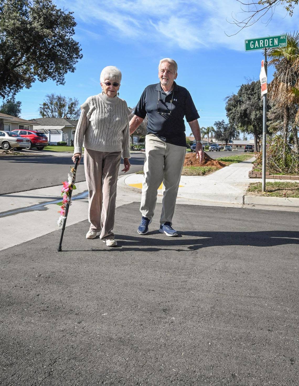 NOW: After more than 50 years of living along crumbling and cracked streets, Bob and Donna Krum walk in their central Fresno neighborhood which was finally repaved and reconstructed, on Tuesday, Feb. 7, 2023.