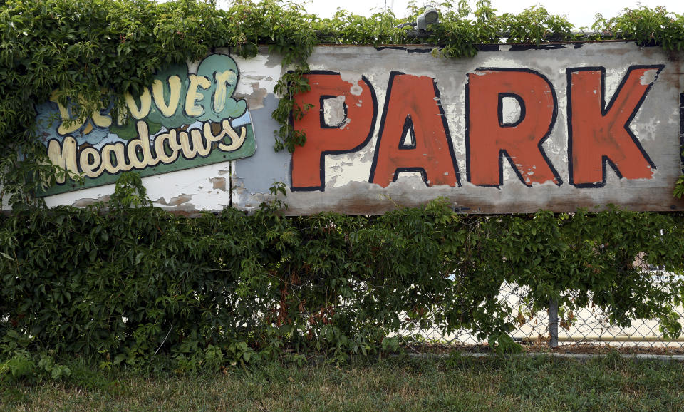 ADVANCE ON THURSDAY, SEPT. 12 FOR USE ANY TIME AFTER 3:01 A.M. SUNDAY SEPT 15 - A faded sign at the Denver Meadows Mobile Home and RV Park stands in Aurora, Colo., on Friday, Aug. 30, 2019. Residents, most of whom have been displaced, tried to buy the park but were unsuccessful. Most of the homes are now abandoned and are slated for demolition as the park closes for possible redevelopment. (AP Photo/Thomas Peipert)