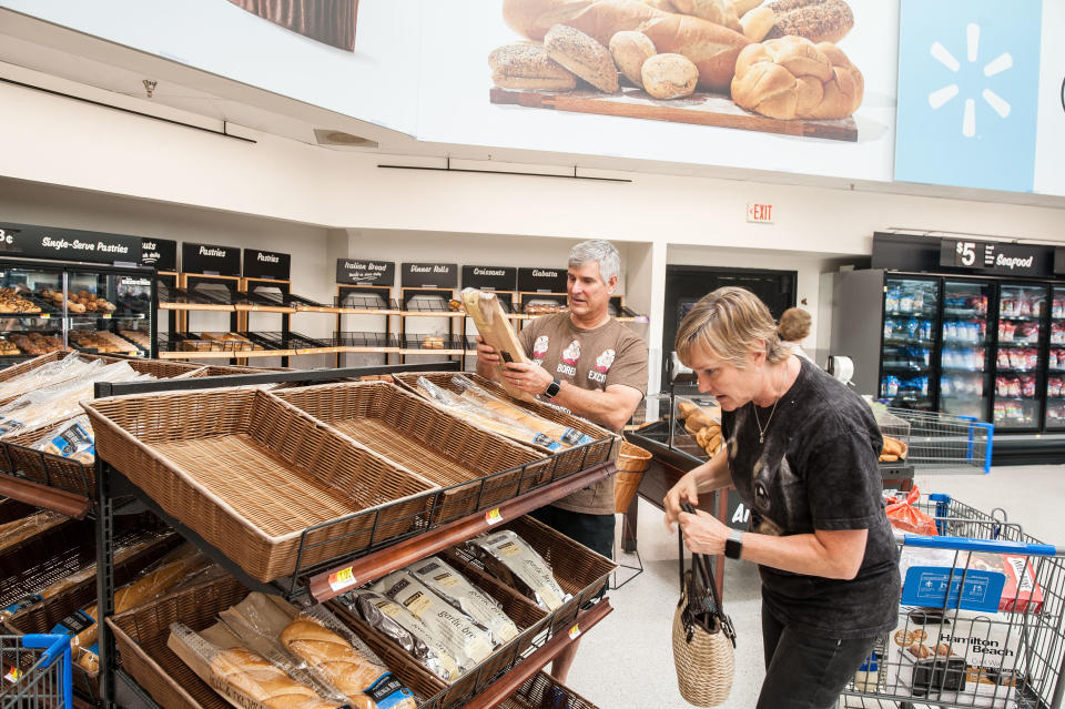 Don and Tammy Snowden, whose home just down the street from the Walmart in Katy, Texas, was flooded, pick up fresh-baked baguettes at the store. (Photo: Joseph Rushmore for HuffPost)