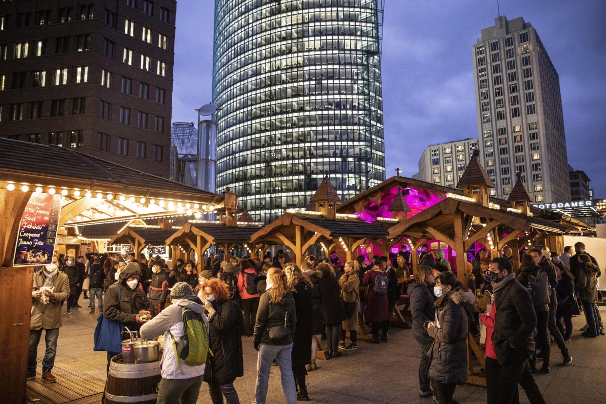 BERLIN, GERMANY - NOVEMBER 19: People stand at Christmas market at Potsdamer Platz on November 19, 2021 in Berlin, Germany. The Bundestag, Germany's parliament, yesterday approved a bill that would impose restrictions, particularly on the unvaccinated, should hospitalisations due to Covid-19 reach specific levels. Germany is struggling to rein in infection rates that have skyrocketed to record levels in recent weeks. (Photo by Maja Hitij/Getty Images)