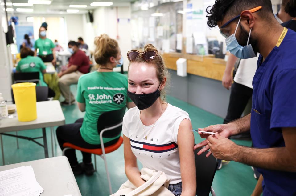 A person receives a dose of the Pfizer BioNTech vaccine (REUTERS)