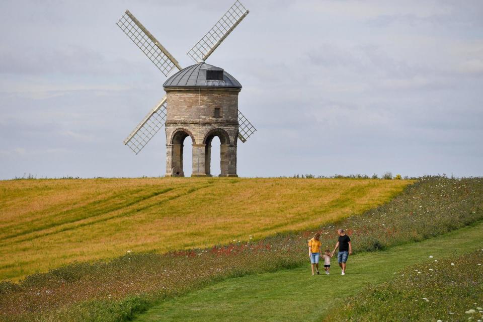 A family is seen at Chesterton Windmill, Warwickshire, on Thursday (PA)