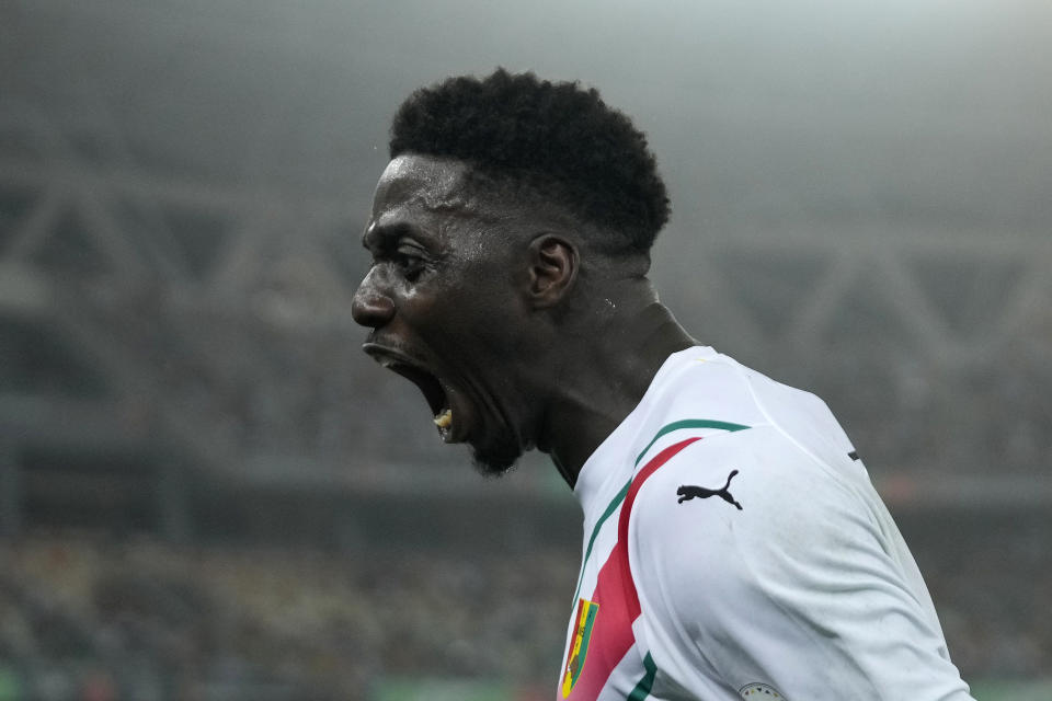 Guinea's Mohamed Bayo celebrates celebrate after scoring his side's goal during the African Cup of Nations Round of 16 soccer match between Equatorial Guinea and Guinea, at the Olympic Stadium of Ebimpe in Abidjan, Ivory Coast, Sunday, Jan. 28, 2024. 2024. (AP Photo/Themba Hadebe)