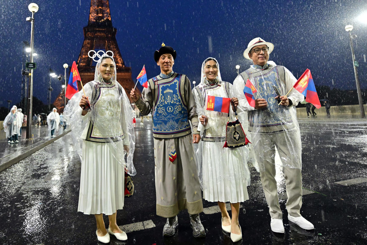 Members of Mongolia's delegation pose on the Iena Bridge during the opening ceremony of the Paris 2024 Olympic Games in Paris on July 26, 2024, as the Eiffel Tower is seen in the background. / Credit: MARTIN  BERNETTI/AFP via Getty Images