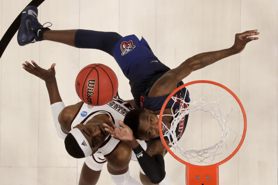 Liberty guard Lovell Cabbil Jr., right, shoots over Mississippi State forward Aric Holman during the second half of a first-round game in the NCAA men’s college basketball tournament Friday, March 22, 2019, in San Jose, Calif. (AP Photo/Ben Margot)