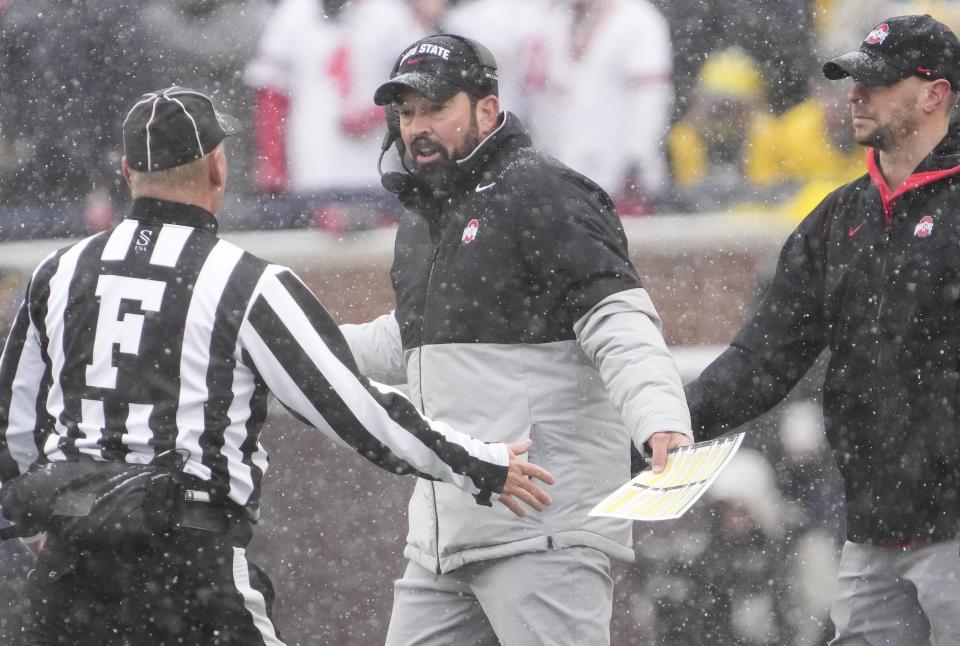 Ohio State Buckeyes head coach Ryan Day talks to an official during the second quarter of the NCAA football game against the Michigan Wolverines at Michigan Stadium in Ann Arbor on Saturday, Nov. 27, 2021.