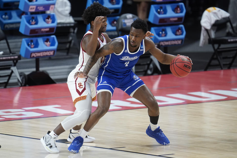 Drake forward ShanQuan Hemphill (4) backs down USC guard Ethan Anderson (20) during the first half of a men's college basketball game in the first round of the NCAA tournament at Bankers Life Fieldhouse in Indianapolis, Saturday, March 20, 2021. (AP Photo/Paul Sancya)