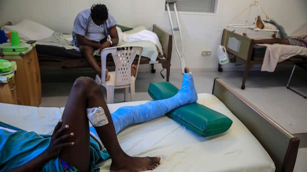 PHOTO: In this Jan. 25, 2023, file photo, a man who was shot in his left foot by a stray bullet, lies on a bed at a clinic run by Doctors Without Borders in the Tabarre neighborhood of Port-au-Prince, Haiti. (Odelyn Joseph/AP, FILE)