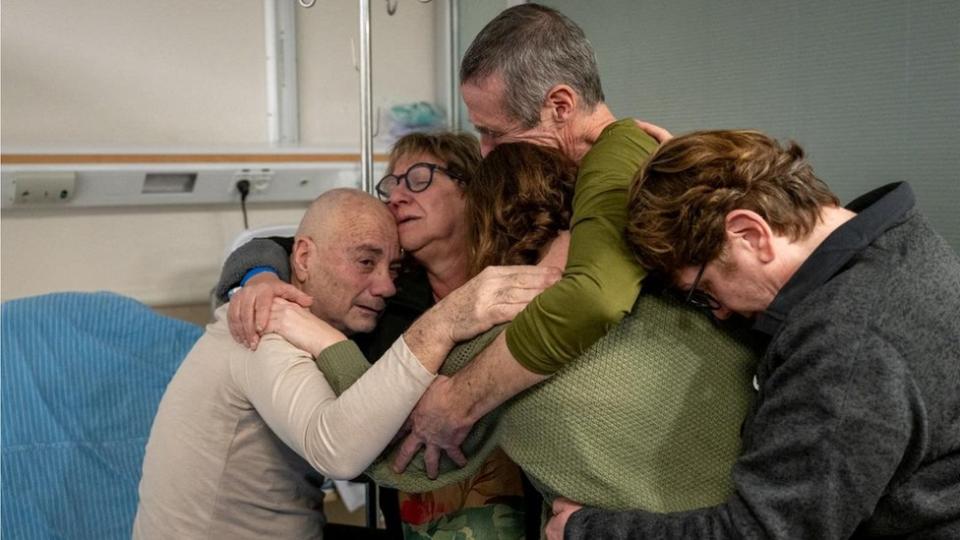 The released hostage embraces her family