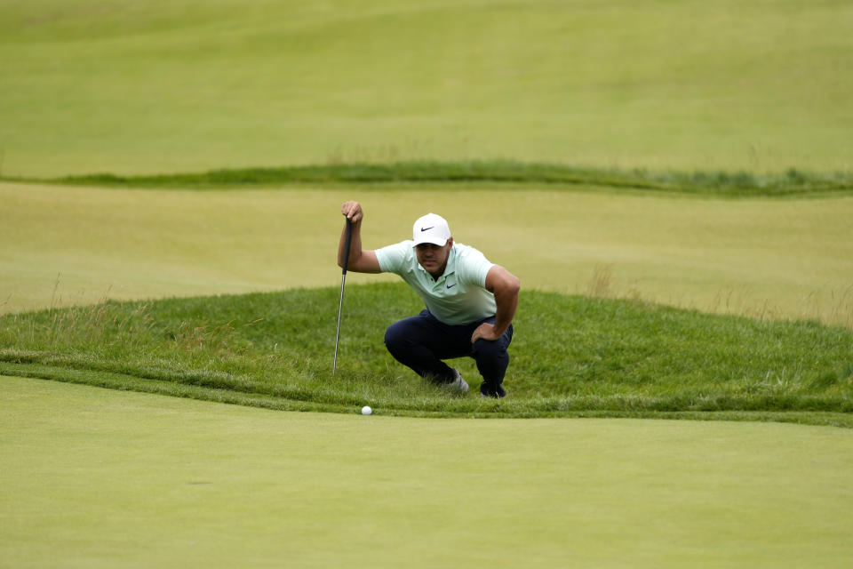 Brooks Koepka prepares to putt on the fourth hole during the third round of the U.S. Open golf tournament at The Country Club, Saturday, June 18, 2022, in Brookline, Mass. (AP Photo/Charles Krupa)