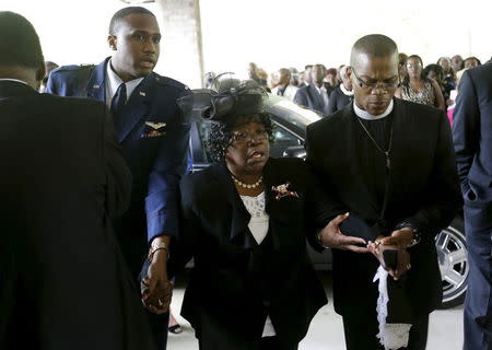 Judy Scott, center, is escorted in for the funeral of her son, Walter Scott, at W.O.R.D. Ministries Christian Center, Saturday, April 11, 2015, in Summerville. Scott was killed by a North Charleston police officer on April 4, 2015. The officer, Michael Thomas Slager, has been charged with murder. REUTERS/David Goldman/Pool