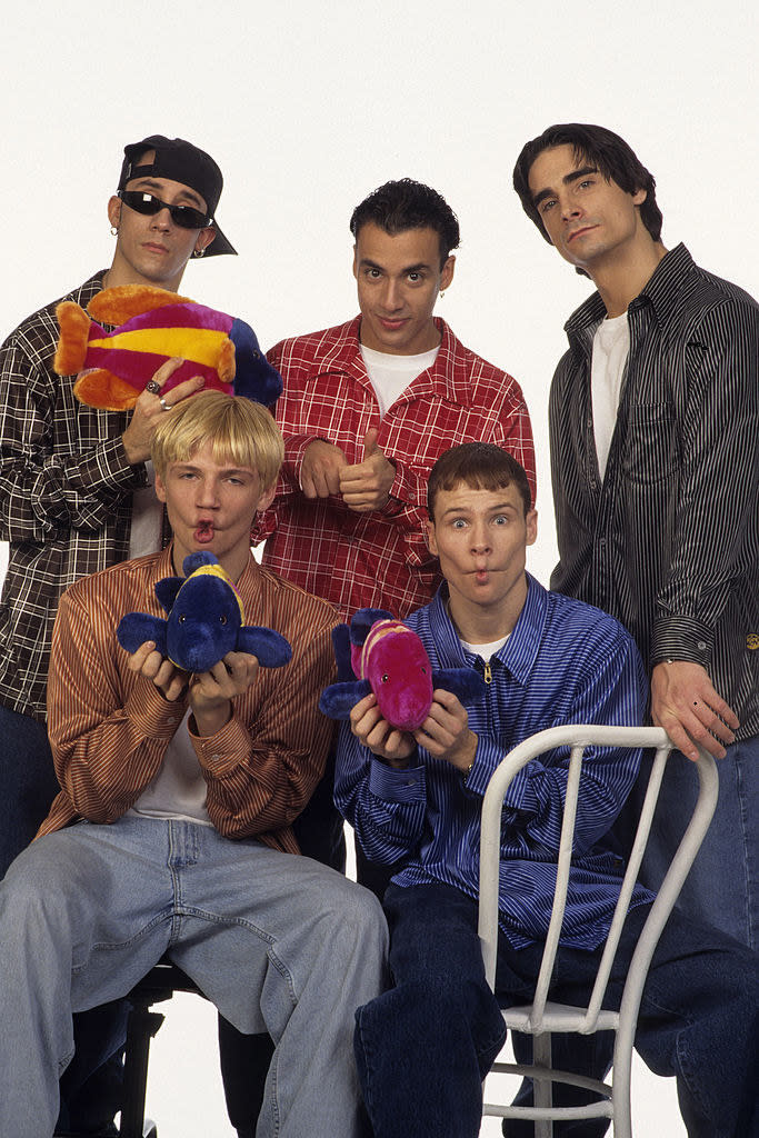 The boys holding stuffed-animal fish