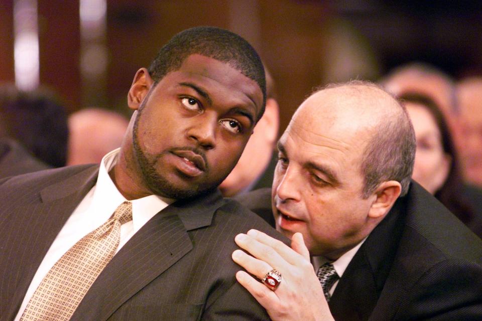 Wisconsin tailback Ron Dayne, left, talks with Wisconsin coach Barry Alvarez during the 1999 Heisman Trophy ceremony on Saturday, Dec. 11, 1999 at the Downtown Athletic Club in New York. Dayne finished his collegiate career with 6,397 yards, the Division 1-A rushing record. Dayne was named the 65th Heisman Trophy winner.