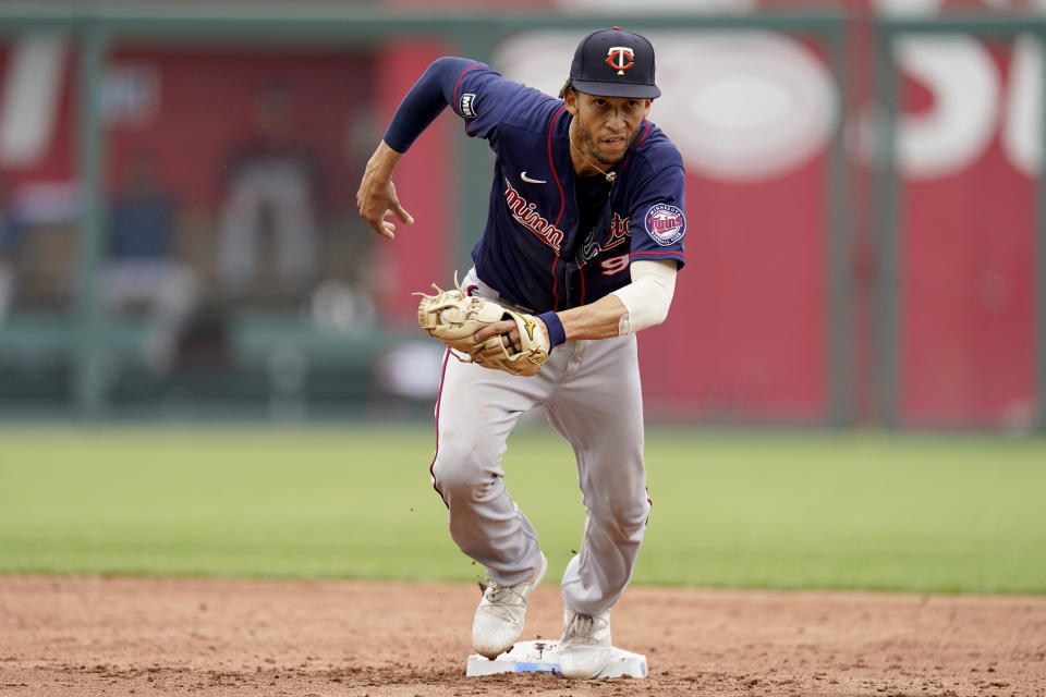 Minnesota Twins shortstop Andrelton Simmons runs towards first to get the final out of a triple play on Kansas City Royals' Cam Gallagher after forcing Jarrod Dyson out at second during the third inning of a baseball game Sunday, June 6, 2021, in Kansas City, Mo. (AP Photo/Charlie Riedel)