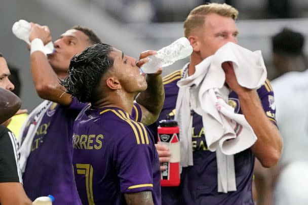 PHOTO: Orlando City's Rafael Santos, Facundo Torres and Robin Jansson, from left, cool off from the heat as play was stopped during the first half of the team's MLS soccer match, July 4, 2023, in Orlando, Fla. (John Raoux/AP)