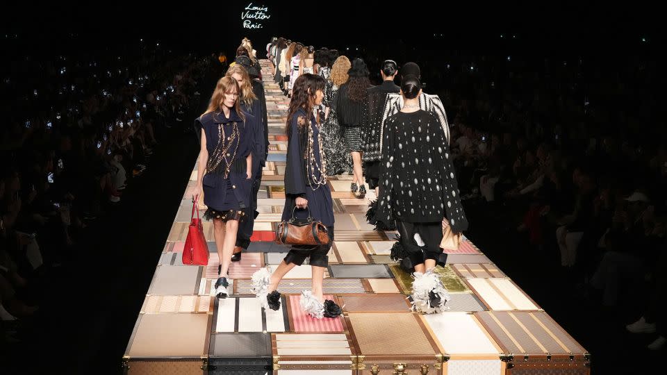 Models walk a runway created from the brand's iconic trunks at Louis Vuitton. - Francois Durand/Getty Images