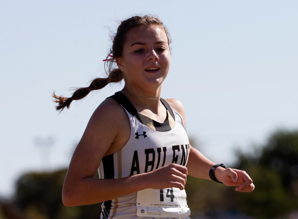 Abilene High's Mason Murray smiles while crossing the finish line during the 5,000 meter run at the District 4-5A cross country meet Thursday, at Mae Simmons Park.