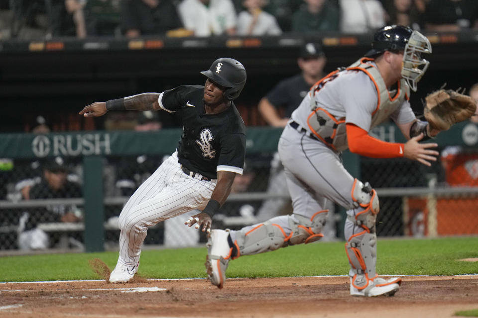 Chicago White Sox's Tim Anderson, left, slides by Detroit Tigers catcher Jake Rogers to score during the third inning of a baseball game Friday, Sept. 1, 2023, in Chicago. (AP Photo/Erin Hooley)