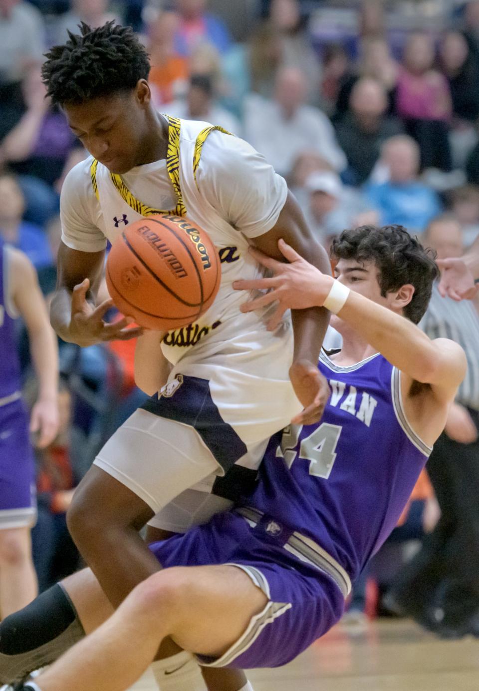 Delavan's Zach McLean (24) tries to strip the ball from Peoria Christian's Kitan Isawumi during their ICAC Tournament semifinal Thursday, Jan. 12, 2023 at Peoria Christian High School in Peoria. The Chargers advanced to the title game with a 61-41 victory over the Panthers.