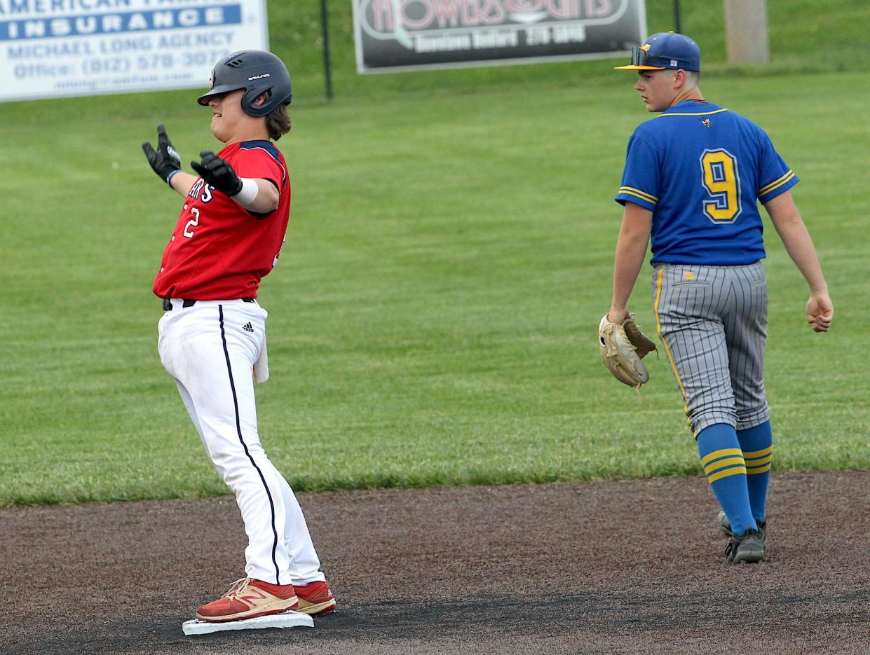 Bedford North Lawrence's Tate Tanksley (2) gestures toward the BNL dugout after getting a double. Mitchell player Conner Teague (9) looks on Friday, May 3, 2024.
