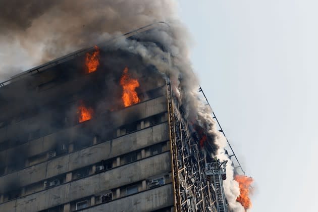 Fire engulfs the 17-story Plasco building, which collapsed today in downtown Tehran. <a href="https://www.theatlantic.com/photo/2017/01/iranian-high-rise-collapses-in-huge-fire-killing-dozens/513671/" rel="nofollow noopener" target="_blank" data-ylk="slk:More photos here;elm:context_link;itc:0;sec:content-canvas" class="link ">More photos here</a>. (AFP / Getty)