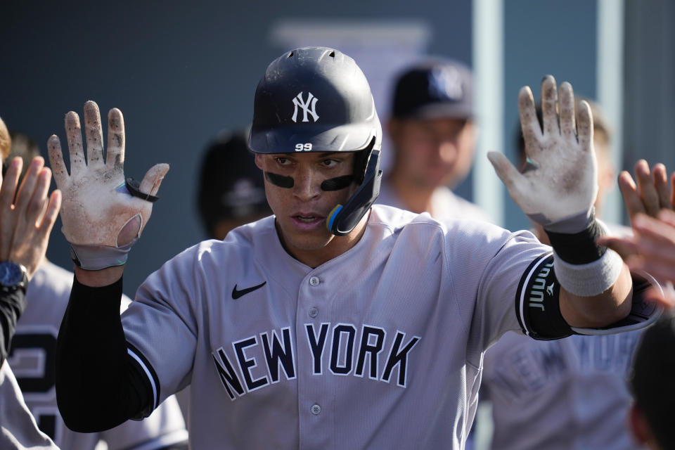 New York Yankees' Aaron Judge (99) celebrates in the dugout after hitting a home run during the sixth inning of a baseball game against the Los Angeles Dodgers in Los Angeles, Saturday, June 3, 2023. (AP Photo/Ashley Landis)