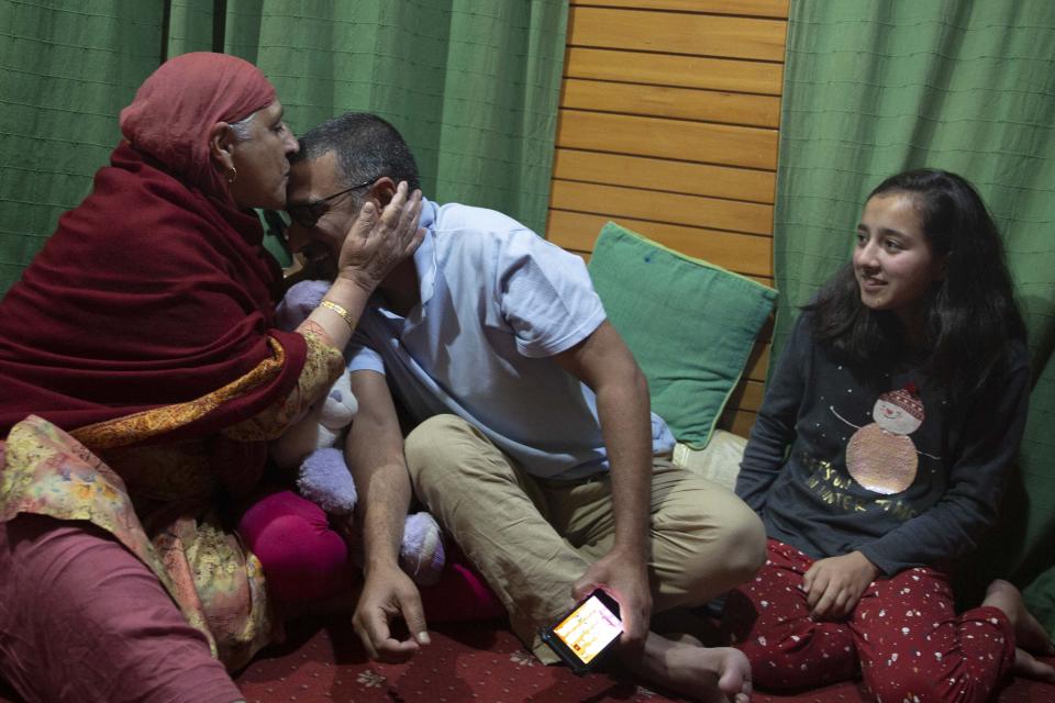 Associated Press photographer Dar Yasin celebrates with his family at his home in Srinagar, Indian controlled Kashmir, Tuesday, April 5, 2020, following the announcement that he was one of three AP photographers who won the Pulitzer Prize in Feature Photography for their coverage of the conflict in Kashmir and in Jammu, India. (AP Photo/Rifat Yasin)