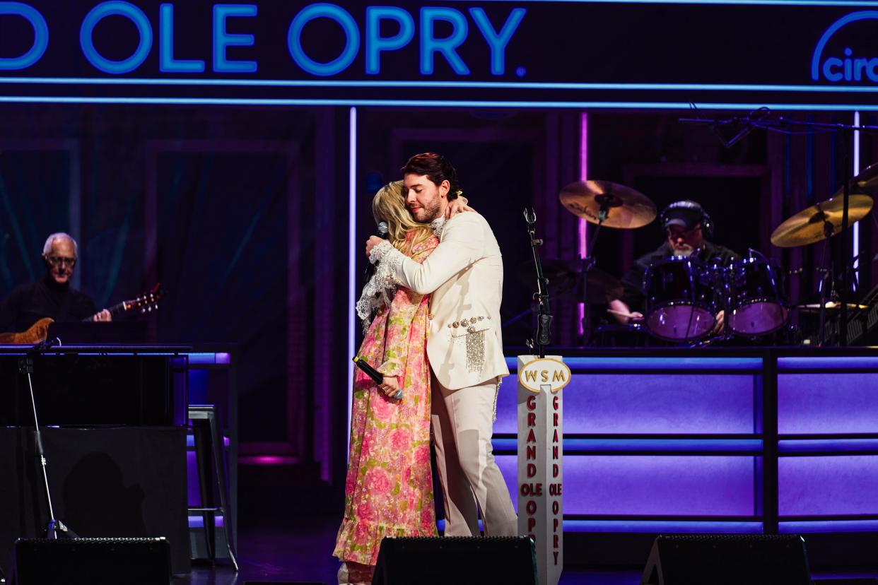 Sam Williams and Carter Faith embrace after performing at the Grand Ole Opry