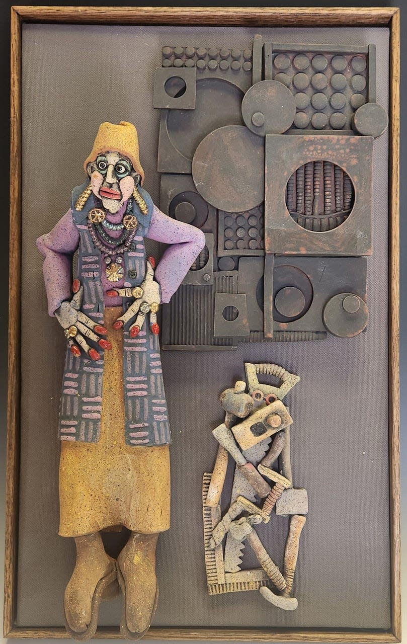 Artist Dee Schaad created this sculpture of a lady with her dog, titled “Louise Nevelson.”