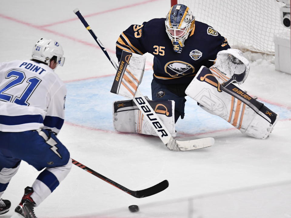 Tampa Bay Lightning Brayden Point (21) take a shot as Buffalo Sabres' goalie Linus Ullman defends during an NHL hockey game in Globen Arena, Stockholm Sweden. Friday. Nov. 8, 2019. (Anders Wiklund/TT via AP)