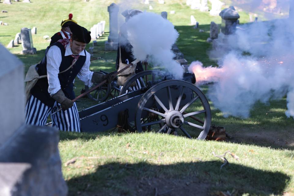 MISSAR members fire a cannon after the grave marker dedications of Samuel Waldron and Archibald Armstrong on Sept. 24, 2023.