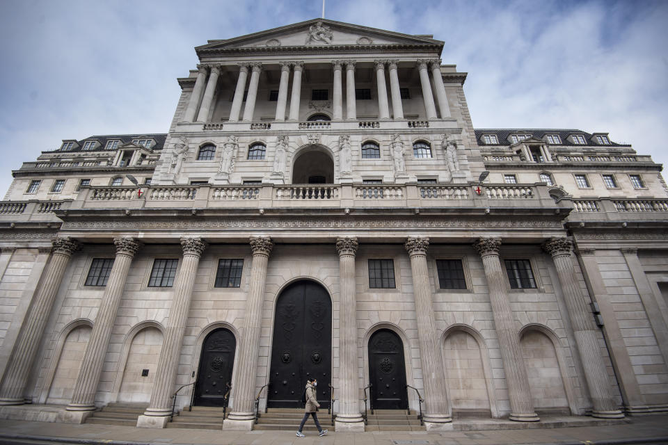 A man in a face mask walks past the Bank of England in the City of London as the UK continues in lockdown to help curb the spread of the coronavirus. (Photo by Victoria Jones/PA Images via Getty Images)