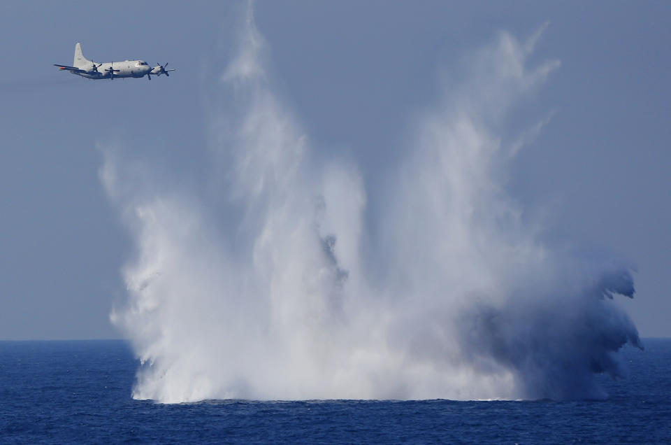 FILE - In this Oct. 18, 2015, file photo, a P-3C anti-submarine patrol plane of the Japan Maritime Self-Defense Force (JMSDF) flies after dropping anti-submarine bombs during the official triennial JMSDF fleet review in the waters off Sagami Bay, south of Tokyo. Japan on Friday, Dec. 27, 2019, approved a contentious plan to send its naval troops to the Middle East to contribute to the peace and stability in the area and ensure the safety of Japanese ships transporting oil, a mission crucial to an energy-poor country that heavily depends on oil imports from the region. (AP Photo/Shizuo Kambayashi, File)