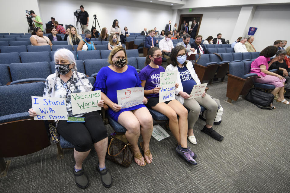 Vaccine advocates wait for the start of a state legislative committee meeting, Wednesday, July 21, 2021, in Nashville, Tenn. Being discussed was the Department of Health vaccine administration following the firing of Dr. Michelle Fiscus, the state's top vaccine official, after state lawmakers complained about efforts to promote COVID-19 vaccination among teenagers. (AP Photo/John Amis)