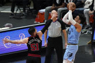 Memphis Grizzlies forward Dillon Brooks, right, shoots against Chicago Bulls guard Ryan Arcidiacono during the second half of an NBA basketball game in Chicago, Friday, April 16, 2021. (AP Photo/Nam Y. Huh)