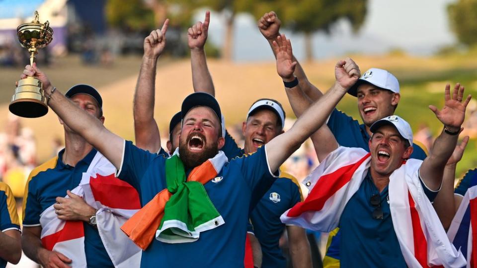 Europe's Shane Lowry celebrates with the Ryder Cup on Sunday alongside Rory McIlroy (right)