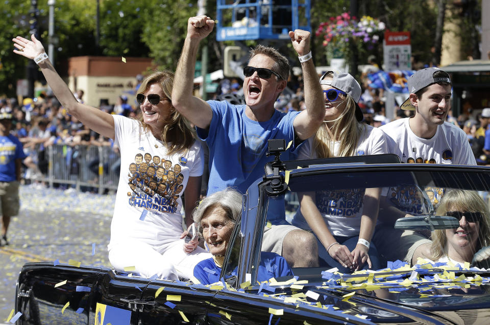FILE - Golden State Warriors head coach Steve Kerr smiles with his family as he rides during a parade and rally for winning the NBA championship in Oakland, Calif., Friday, June 19, 2015. The biggest names on the U.S. World Cup roster might be those who’ll be wearing polo shirts instead of jerseys on game days. Team USA head coach Steve Kerr is a nine-time NBA champion; five as a player, four as a coach. (AP Photo/Jeff Chiu, File)