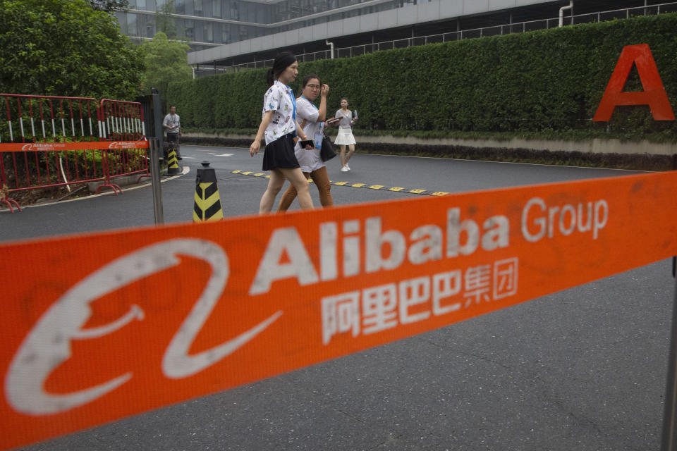 Workers pass by a checkpoint into the Alibaba Group headquarters in Hangzhou in eastern China's Zhejiang province on Friday, May 27, 2016. Chinese regulators on Thursday, Dec. 24, 2020 announced an anti-monopoly investigation of e-commerce giant Alibaba Group, stepping up official efforts to tighten control over China's fast-growing tech industries. (AP Photo/Ng Han Guan)