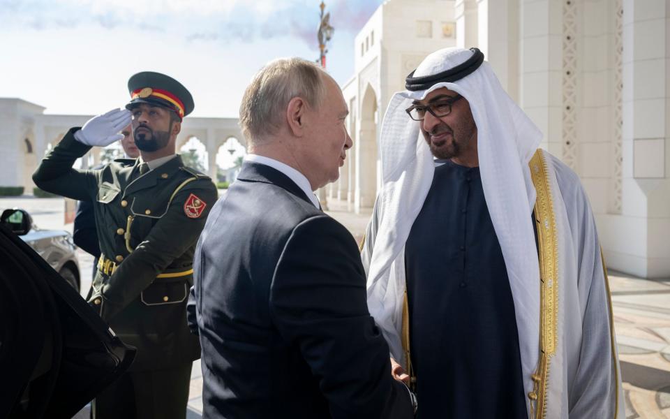 President of the United Arab Emirates Sheikh Mohamed bin Zayed Al Nahyan (R) with Russian President Vladimir Putin (L) during a state visit reception at Qasr Al Watan, in Abu Dhabi