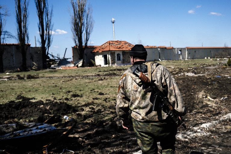 A pro-Russian rebel stands guard in the village of Spartak near Donetsk airport on April 10, 2015