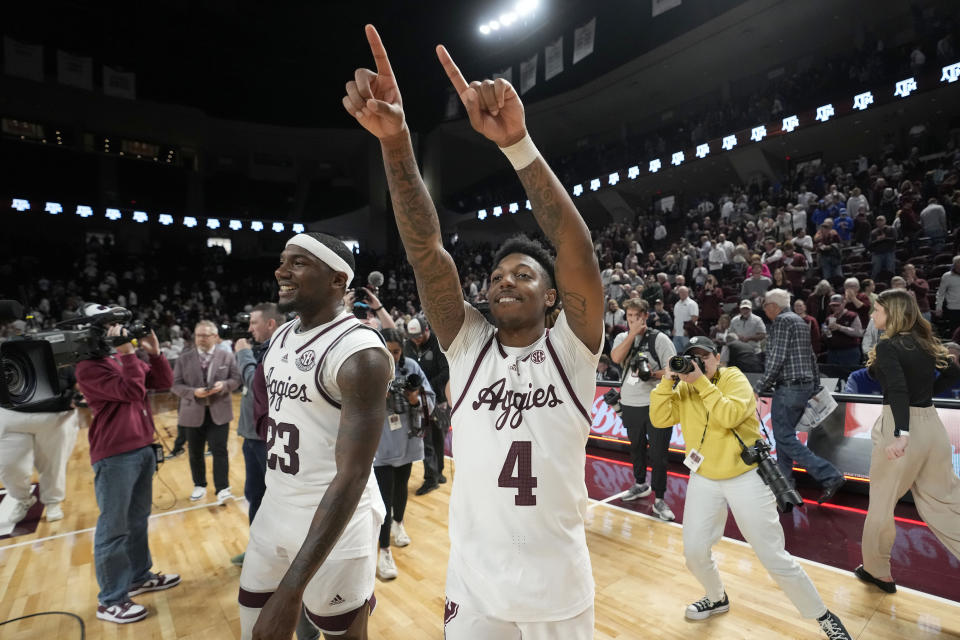 Texas A&M guard's Wade Taylor IV (4) and Tyrece Radford (23) react after beating Kentucky in overtime in an NCAA college basketball game Saturday, Jan. 13, 2024, in College Station, Texas. (AP Photo/Sam Craft)