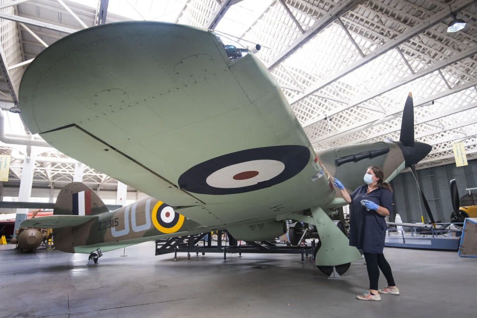 Embargoed to 0001 Tuesday September 15 File photo dated 18/08/20 of Samantha Archetti, Collections Care Technician, cleaning a Hurricane ahead of the reopening of the Battle of Britain exhibition at IWM Duxford, which marks 80 years since the German Luftwaffe began its air attacks at the start of the Battle of Britain. Issue date: Tuesday September 15, 2020. The battle was a major air campaign fought in the skies over the UK in 1940 and was the first battle in history fought entirely in the air. Though the battle took place between July and October 1940, September 15 saw the British Royal Air Force (RAF) gain a decisive victory over the Luftwaffe in what was Nazi Germany�s largest daylight attack. A variety of tributes and commemorations will take place across the UK to mark the 80th anniversary of the Battle of Britain despite limitations caused by the coronavirus crisis. See PA story MEMORIAL Battle. Photo credit should read: Victoria Jones/PA Wire