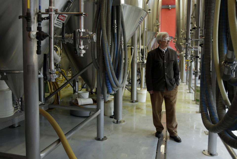 Tom Schlafly, co-founder of the brewery which produces the Schlafly brand of beers, poses for a photo inside Schlafly Bottleworks on Wednesday, March 12, 2014, in Maplewood, Mo. Schlafly has been in a trademark dispute with his aunt, conservative activist Phyllis Schlafly, over whether Schlafly is primarily a last name or a commercial brand that deserves legal protection. (AP Photo/Jeff Roberson)