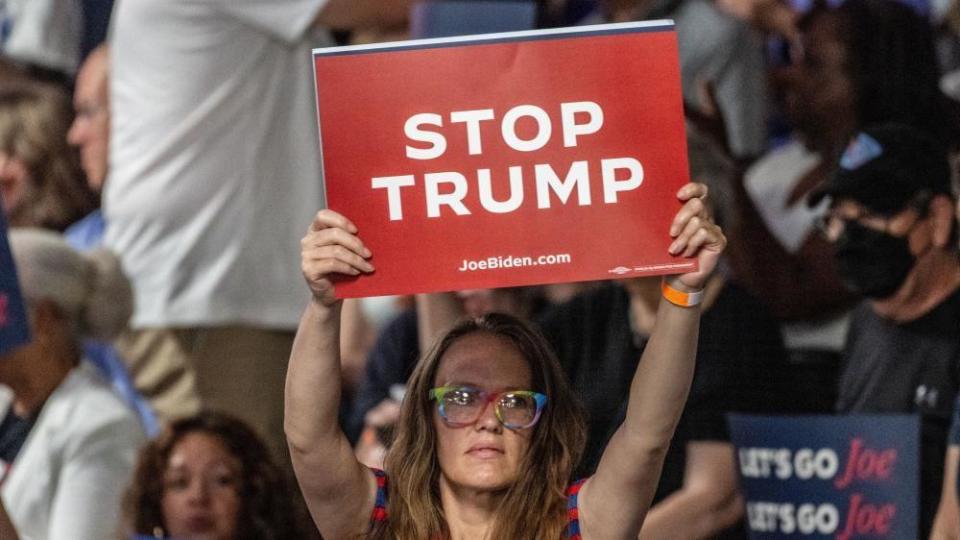 A Joe Biden supporter holds up a sign that reads: "Stop Trump"