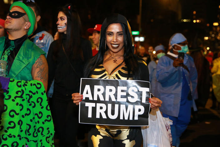 <p>People carry political signs to the 45th annual Village Halloween Parade in New York City on Oct. 31, 2018. (Gordon Donovan/Yahoo News) </p>